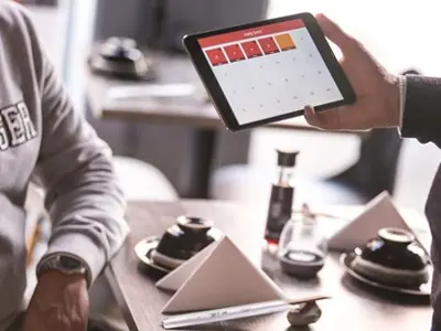 Server using a tablet to take an order