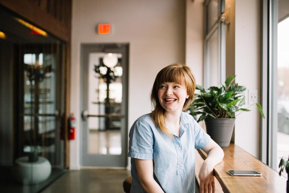 A girl smiling at a counter