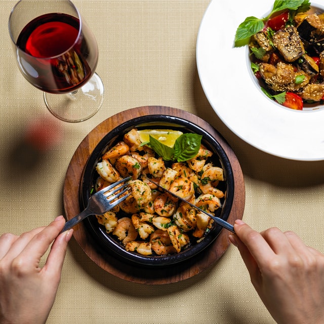 A customer eating a seafood dish