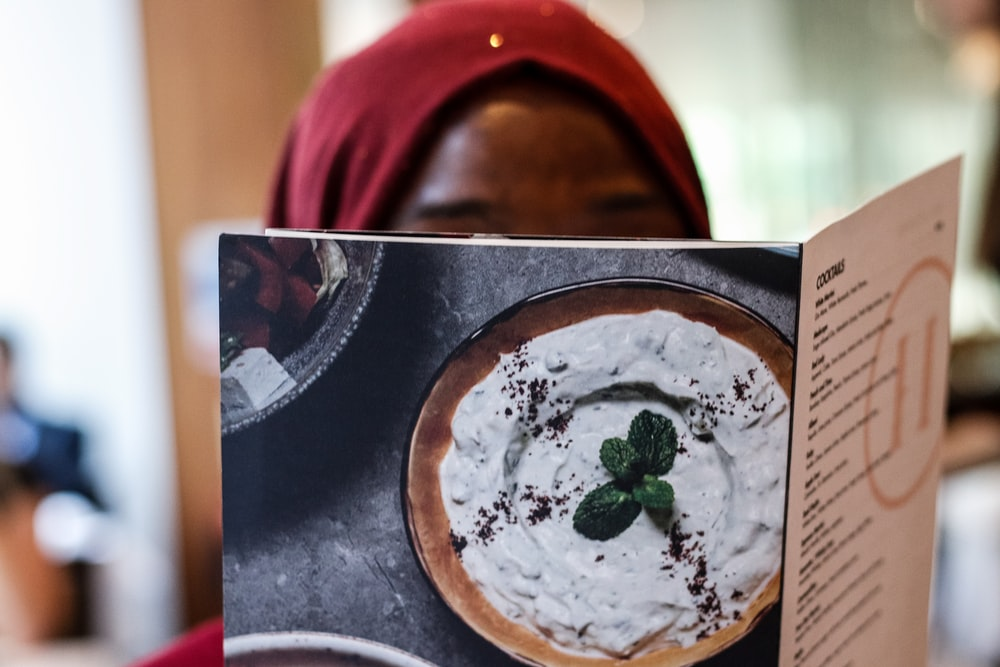 Women peeking at a menu